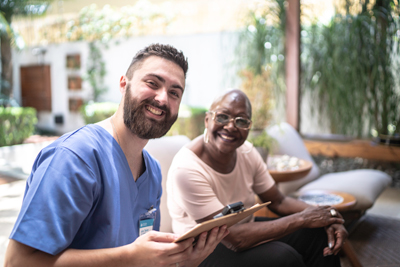 Nurse and patient smiling for the camera