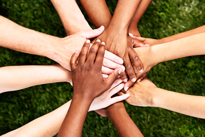 Group of multi ethnic hands clasping