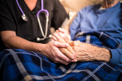 Closeup of doctor holding patient's hands